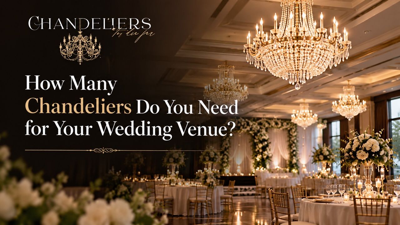 Crystal chandeliers hanging above a styled wedding reception ballroom